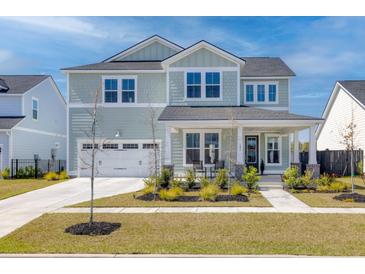 Charming two-story home with a manicured lawn, two-car garage, and welcoming front porch perfect for relaxation at 181 Ashworth Dr, Summerville, SC 29486