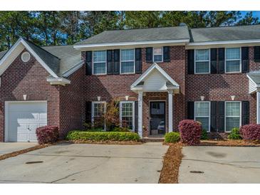Charming brick townhouse with well-manicured landscaping and a private driveway at 219 Tuscany Ct, Ladson, SC 29456