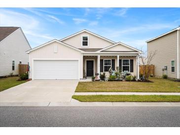 Inviting single-story home features a covered porch, well-maintained landscaping, and two-car garage at 226 Clydesdale Cir, Summerville, SC 29486