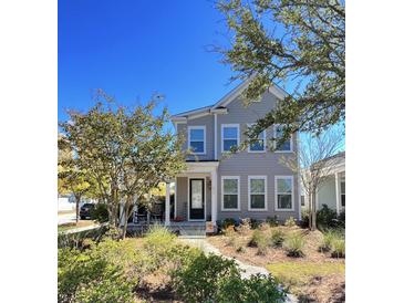 Charming two-story home with welcoming front porch and landscaped garden beds at 251 Summers Dr, Summerville, SC 29485