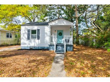 Charming single-story home with a welcoming blue door and beautiful, mature landscaping at 2604 Ferrara Dr, North Charleston, SC 29405