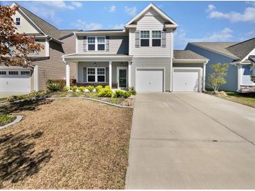 Charming two-story home with a well-manicured lawn and two-car garage, perfect for Gathering living at 359 Dunlin Dr, Summerville, SC 29486