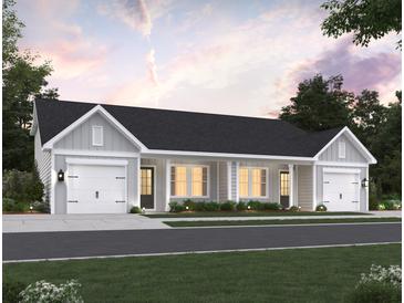 Charming one-story home with white siding, a black roof, two garages, and a neatly landscaped front yard at 960 Dusk Dr, Summerville, SC 29486