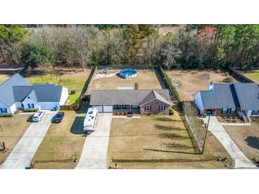 Sprawling property features an above-ground pool and charming brick home with RV parking at 112 Lois Cir, Moncks Corner, SC 29461