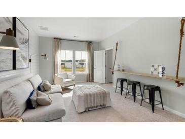 Bright living room featuring a comfortable sofa, natural light, and stylish decor at 114 Snow St, Summerville, SC 29486
