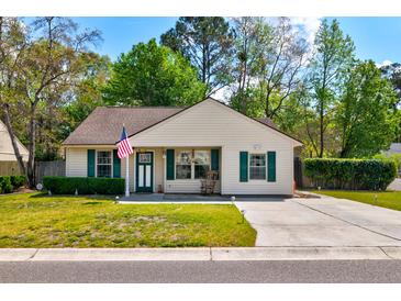 Charming single-story home features green shutters, tidy landscaping, and an inviting front porch at 1257 Maryland Dr, Ladson, SC 29456