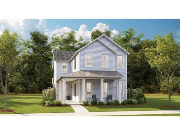 Charming two-story home with a welcoming front porch, lush lawn and classic blue siding, creating a picturesque curb appeal at 136 Maritime Way, Summerville, SC 29485