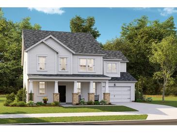 Charming two-story home featuring a welcoming front porch, attached garage, and traditional architectural details at 197 Belfort Pl, Summerville, SC 29486