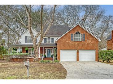 Charming two-story home featuring a brick facade, two-car garage, and a welcoming front porch at 2072 Middleburg Ln, Mount Pleasant, SC 29464