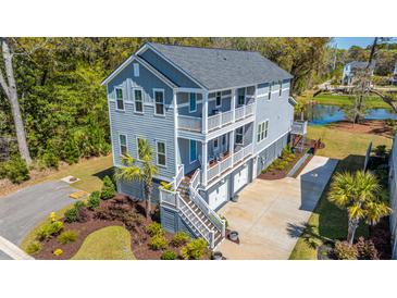 Beautiful gray three-story home with double balconies and garage at 2322 Dorado Ct, Johns Island, SC 29455