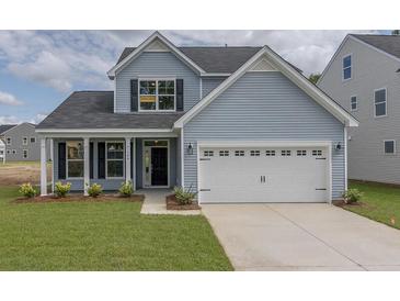 Charming two-story home with a two-car garage and well-manicured lawn at 234 Silk Oak Dr, Moncks Corner, SC 29461