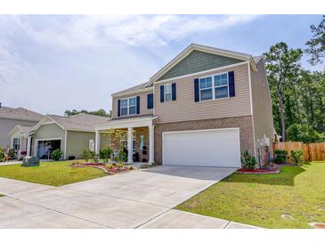 Charming two-story home with a manicured lawn and a two-car garage in a Gathering-friendly neighborhood at 243 N Light Way, Summerville, SC 29486