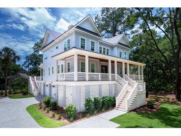 Stately two-story home with a charming front porch and beautiful landscaping at 2501 Clear Marsh Rd, Seabrook Island, SC 29455