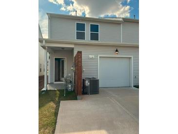 Two-story home featuring a two-car garage, vinyl siding, and updated landscaping at 280 Godwit Dr, Summerville, SC 29486