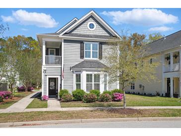 Charming two-story home with a cozy front porch and beautifully landscaped front yard at 3020 Plumier Pl, Charleston, SC 29414