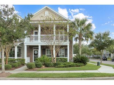 Charming two-story home with brick facade, double porches, and lush landscaping at 3025 Lazarette Ln, Charleston, SC 29414
