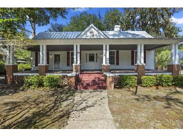 Charming home with a full covered front porch, brick pillars, and a landscaped yard at 311 Black St, Walterboro, SC 29488