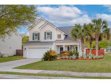 Charming two-story home featuring a manicured lawn, palm trees and an attached two-car garage at 9400 Divot Ln, Summerville, SC 29485