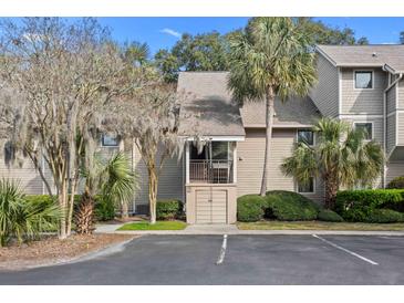 Inviting condo with palm trees and beautiful landscaping at 157 High Hammock Villas, Seabrook Island, SC 29455