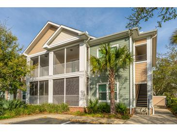 Attractive two-story condo with screened patios, green and beige siding, and mature landscaping at 1755 Central Park Rd # 3102, Charleston, SC 29412
