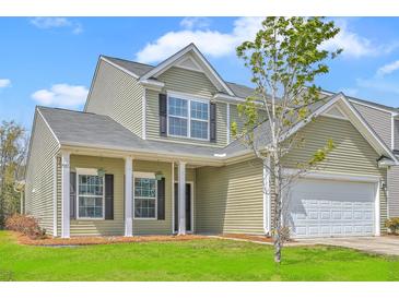 Charming two-story home with green siding, white trim, and a well-manicured front lawn at 189 Weeping Cypress Dr, Moncks Corner, SC 29461