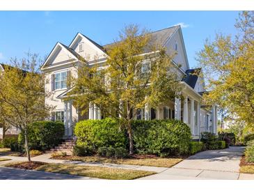 Charming two-story home boasts a landscaped yard and classic architectural details at 278 Furman Farm Pl, Daniel Island, SC 29492