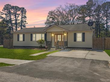 Charming one-story home with a well-maintained lawn and cozy front porch at 4701 Ivydale Dr, North Charleston, SC 29405