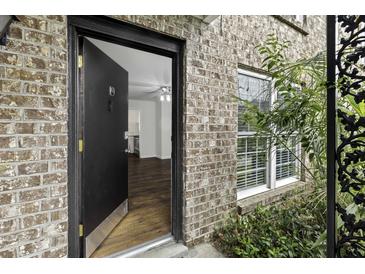 Inviting brick home featuring a glimpse of the hardwood floors through an open entryway at 874 Colony Drive # B19, Charleston, SC 29407