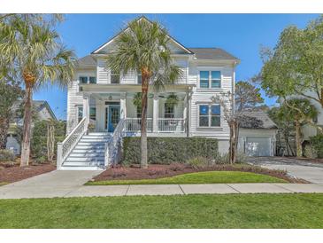 Charming two-story home with a welcoming front porch and well-manicured lawn and a bright blue front door at 1115 Barfield St, Charleston, SC 29492