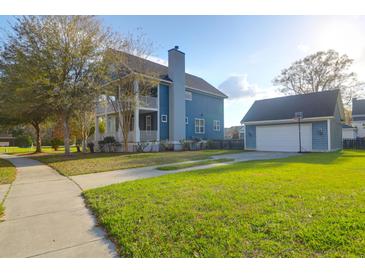 Beautiful two-story home with a well-maintained lawn and detached garage with a basketball hoop at 2107 Military Way, Charleston, SC 29414