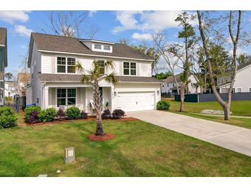 Charming two-story home featuring a manicured front lawn, covered porch, and attached two-car garage at 2830 Backman St, Mount Pleasant, SC 29466