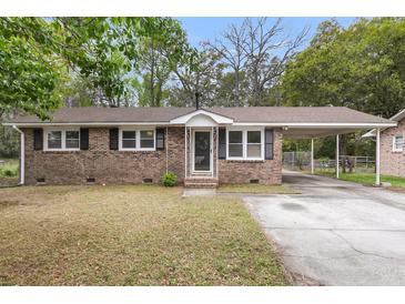 Charming brick home with a covered parking, well-maintained lawn, and mature trees at 4757 June St, North Charleston, SC 29405