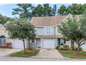 Charming townhome featuring an attached garage, well-manicured lawn, and mature trees at 601 Buckthorn Cir, Summerville, SC 29483
