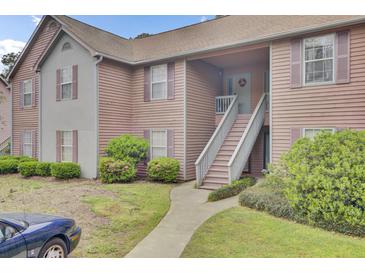 Inviting two-story condo with charming curb appeal, front stairs, and well-maintained landscaping at 7940 Parklane Ct # F, North Charleston, SC 29418