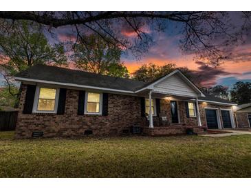 Charming brick home with black shutters, attached garage, and welcoming front porch at sunset at 103 Beverly Dr, Ladson, SC 29456