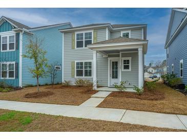 Charming two-story home with a covered porch and neutral siding, complemented by a well-maintained front yard at 143 Brant Dr, Summerville, SC 29483