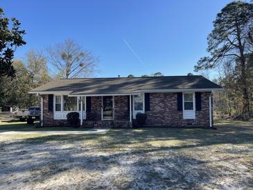 Cozy brick home featuring classic shutters, a welcoming front porch, and a well-maintained front yard at 260 Carolina Cir, Walterboro, SC 29488