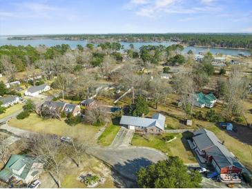 An aerial view of a charming waterfront neighborhood with lush greenery and lake views at 305 Meadowlark Ln, Moncks Corner, SC 29461