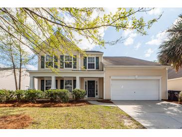 Charming two-story home featuring a well-manicured front yard and an attached two-car garage at 3529 Galaxy Rd, Ladson, SC 29456