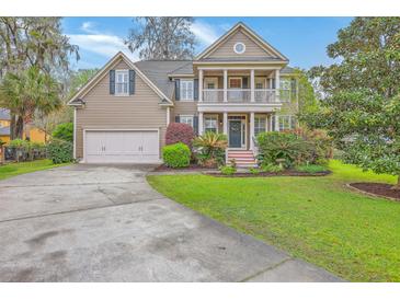 Charming two-story home featuring a spacious front yard, two-car garage, and a welcoming double-decker porch at 5411 Nesting Pl, North Charleston, SC 29420