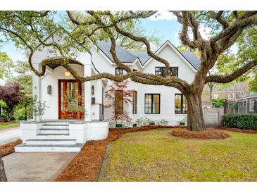 Charming two-story home with a landscaped yard and covered front porch and beautiful mature tree at 6 Beverly Rd, Charleston, SC 29407