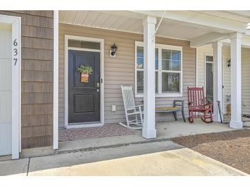 Inviting front porch with rocking chairs and a charming entrance, perfect for relaxing outdoors at 637 Hilchot Dr, Summerville, SC 29486