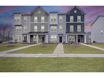 Charming row of townhomes with manicured lawns offers curb appeal and comfortable living at 861 Recess Point Dr, Moncks Corner, SC 29461