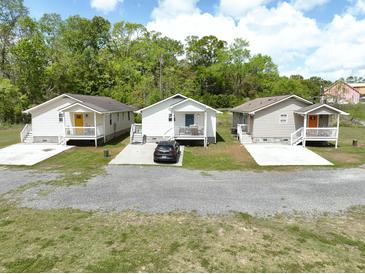 Three quaint homes with colorful doors, each boasting a charming front porch at 0 James Bell Dr, North Charleston, SC 29406