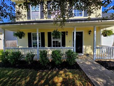 Charming home featuring a welcoming front porch and well-maintained landscaping at 104 Queen Mary Ct, Summerville, SC 29485