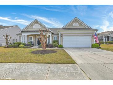 Charming single-story home with manicured lawn, tidy landscaping, covered porch, and attached two-car garage at 145 Billowing Sails St, Summerville, SC 29486