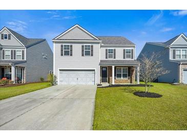 Charming two-story home with a well-manicured lawn, a two-car garage, and neutral siding at 158 Netherfield Dr, Summerville, SC 29486