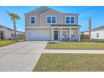 Charming two-story home with a well-manicured lawn and welcoming front porch at 159 Lucky Day Dr, Summerville, SC 29486