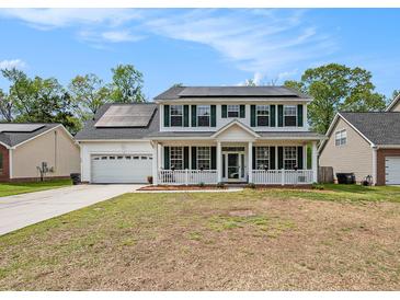 Charming two-story home featuring a welcoming front porch and solar panels on the roof at 176 Hainsworth Dr, North Charleston, SC 29418