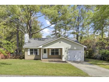 Charming single Gathering home with a brick facade, attached garage and well-kept lawn at 213 Braly Dr, Summerville, SC 29485